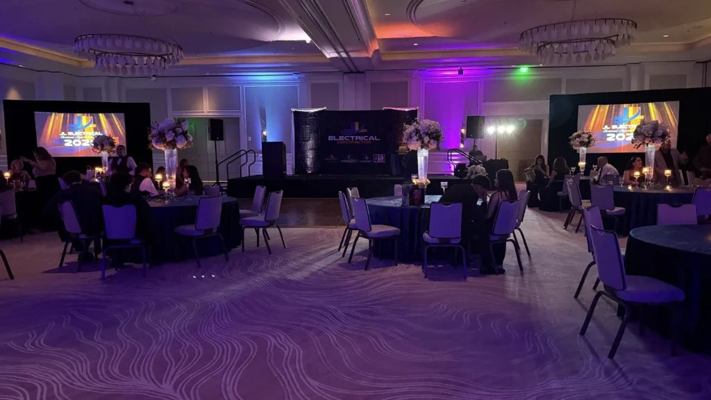 Corporate AV stage with sound system, microphones and event lighting