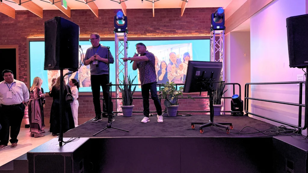 Corporate AV stage with sound system, microphones and event lighting