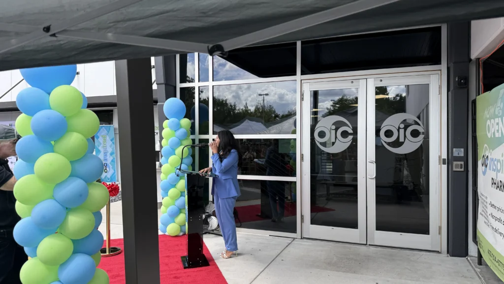 Outdoor ribbon-cutting ceremony with podium microphone and sound support