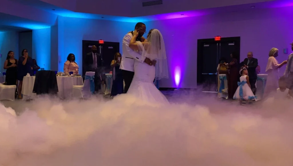 Bride and groom sharing their first dance with a low-lying cloud effect at an Orlando wedding